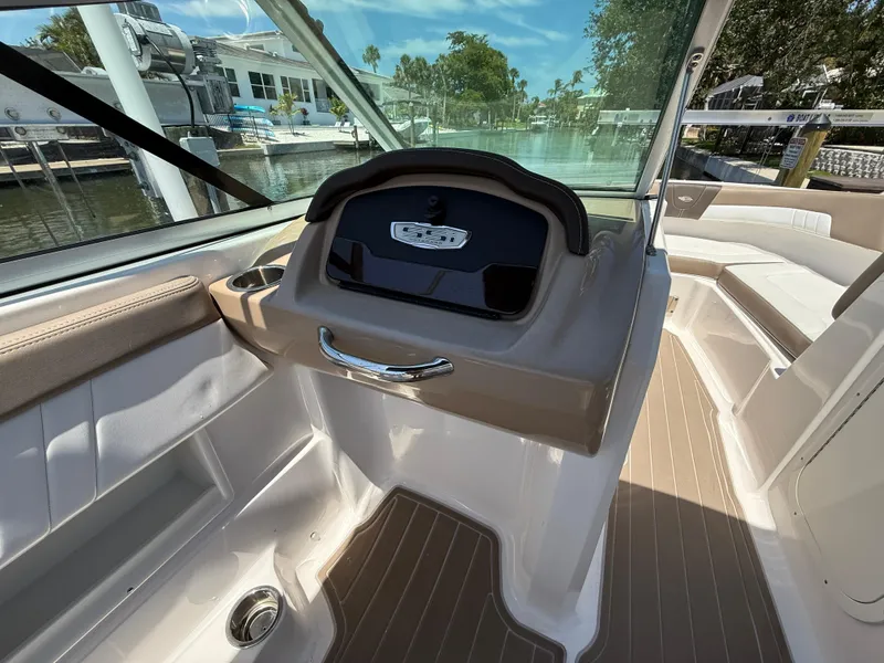 Slide: The Image of 2021 Chaparral 23 SSi OB boat interior with helm and seating area. - 12