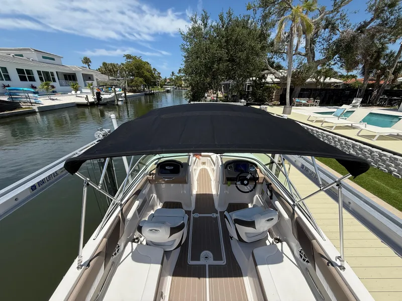 Slide: The Image of 2021 Chaparral 23 SSi OB boat docked by a scenic canal. - 17
