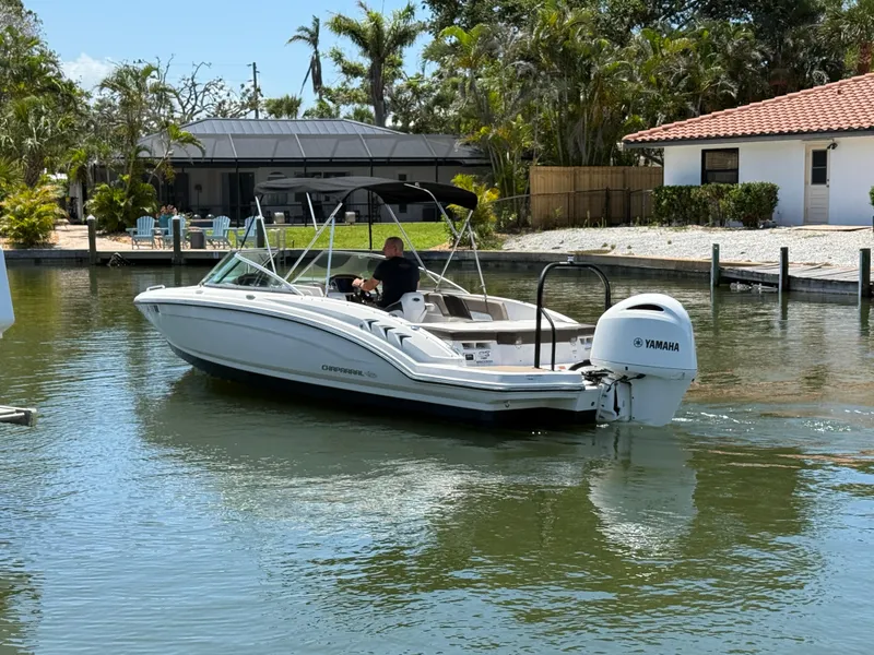 Slide: The Image of 2021 Chaparral 23 SSi OB boat cruising on a sunny day near a waterfront home. - 5
