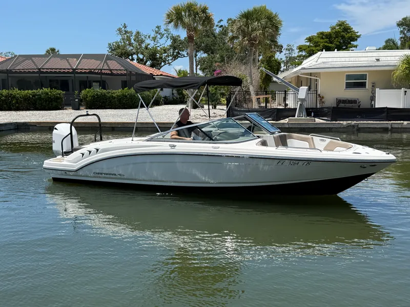 Slide: The Image of 2021 Chaparral 23 SSi OB boat on calm water near residential area. - 6