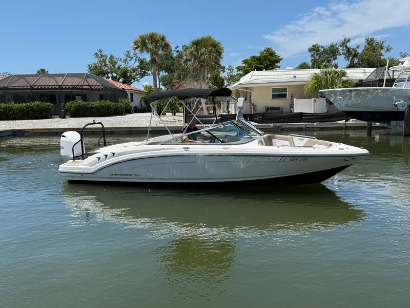 Slide: The Image of 2021 Chaparral 23 SSi OB boat on calm water near residential area. - 7