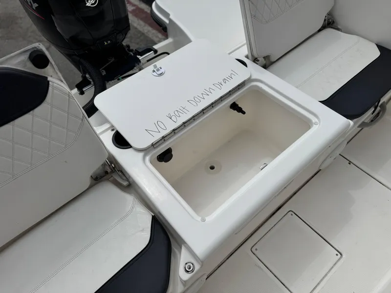 Slide: The Image of 2022 Bayliner Trophy T22CC boat with open storage compartment and seating. - 15