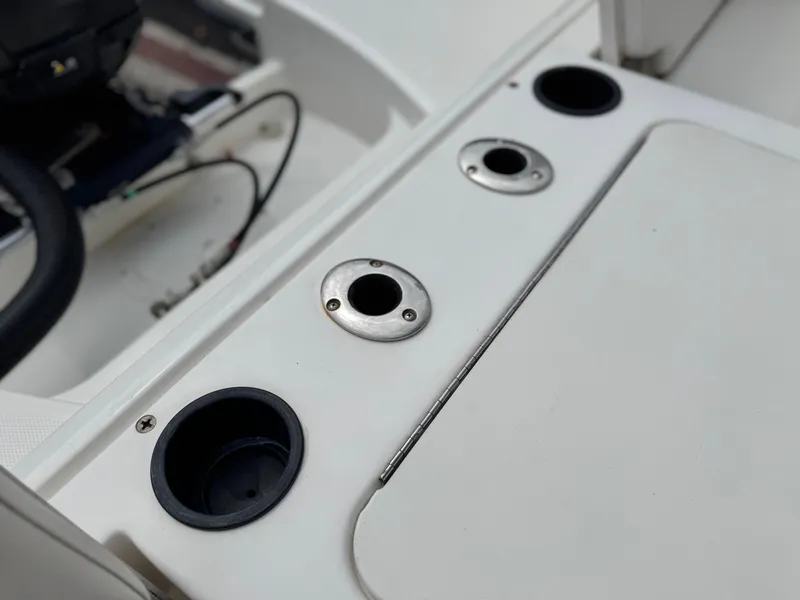 Slide: The Image of 2022 Bayliner Trophy T22CC boat console with cup holders and rod holders. - 16