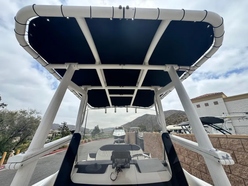 Slide: The Image of 2022 Bayliner Trophy T22CC boat with T-top, parked outdoors. - 19