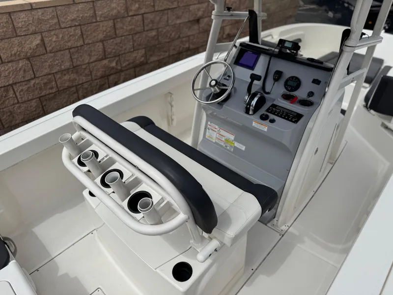 Slide: The Image of 2022 Bayliner Trophy T22CC boat console with steering wheel and rod holders. - 21