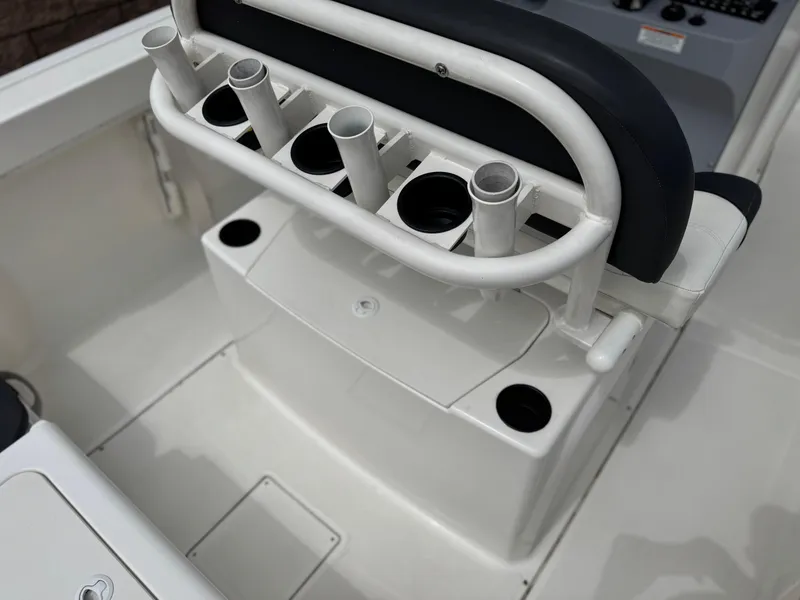 Slide: The Image of 2022 Bayliner Trophy T22CC boat interior with rod holders and storage compartments. - 22