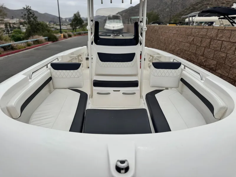 Slide: The Image of 2022 Bayliner Trophy T22CC boat interior with cushioned seating and sleek design. - 7