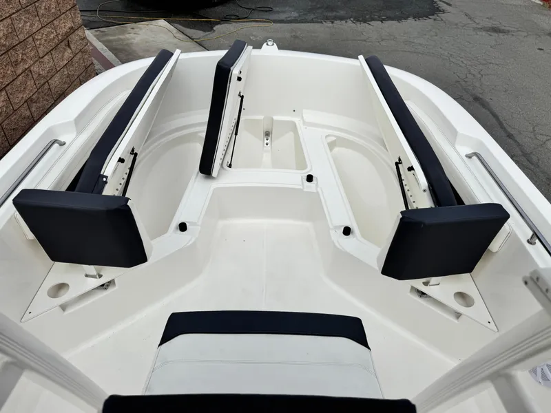 Slide: The Image of 2022 Bayliner Trophy T22CC boat interior with cushioned seating and storage compartments. - 9