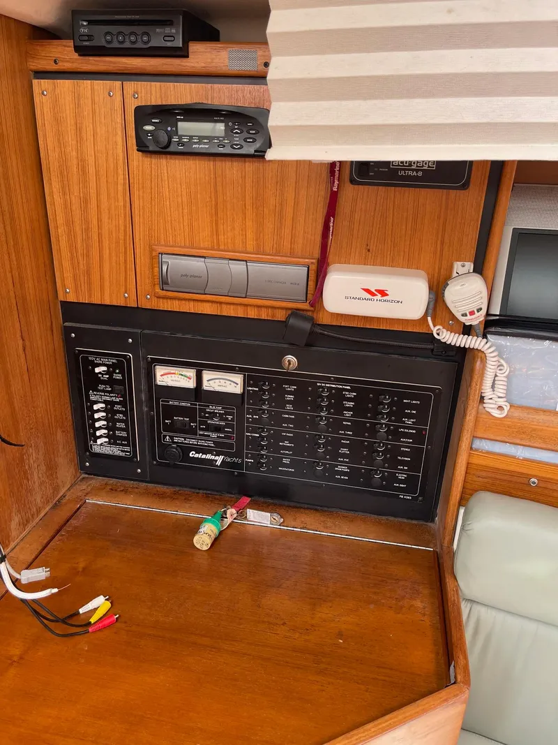 Slide: The Image of Control panel of a 2004 Catalina 350 sailboat with radio and electrical switches. - 17