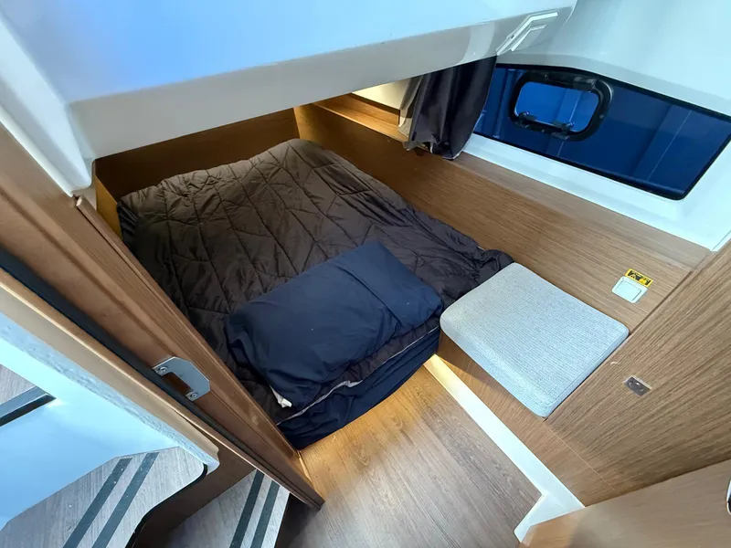 Slide: The Image of 2021 Jeanneau NC Weekender 1095 cabin interior with cozy bed and wooden finish. - 14