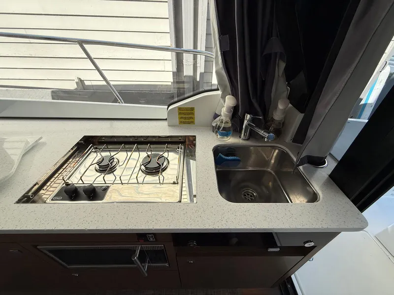 Slide: The Image of 2021 Jeanneau NC Weekender 1095 kitchen with stove and sink. - 20
