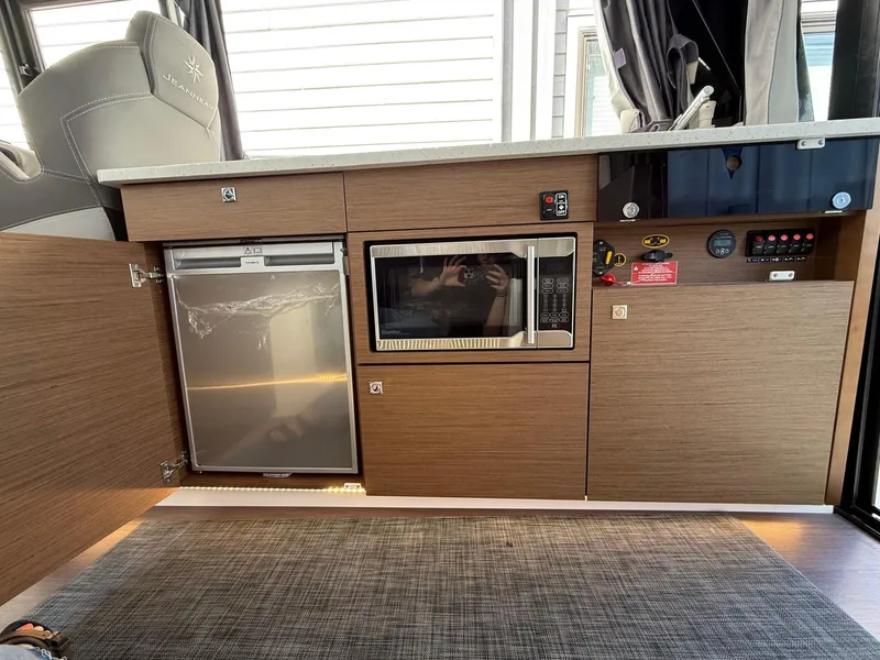 Slide: The Image of Interior of 2021 Jeanneau NC Weekender 1095 showing kitchen appliances and cabinetry. - 22