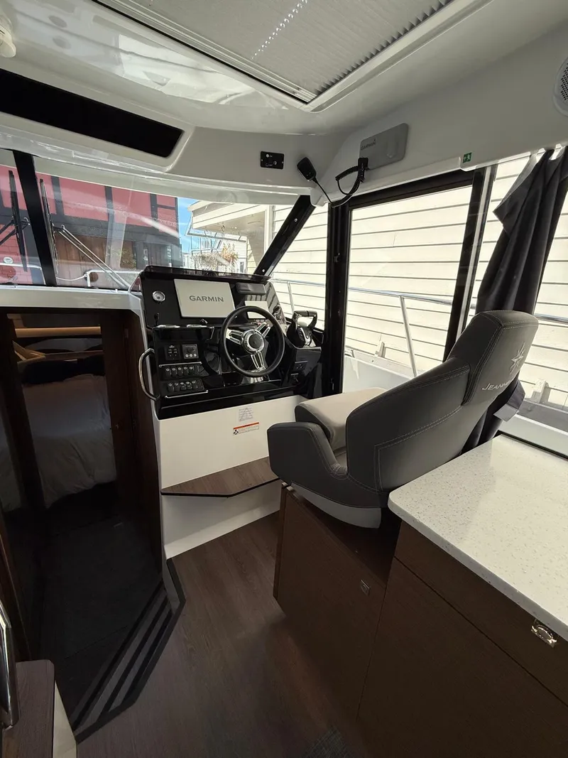 Slide: The Image of 2021 Jeanneau NC Weekender 1095 interior with helm station and seating. - 6