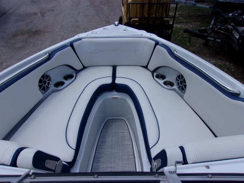 Slide: The Image of 2021 Crownline 210SS boat interior with white seating and cup holders. - 11