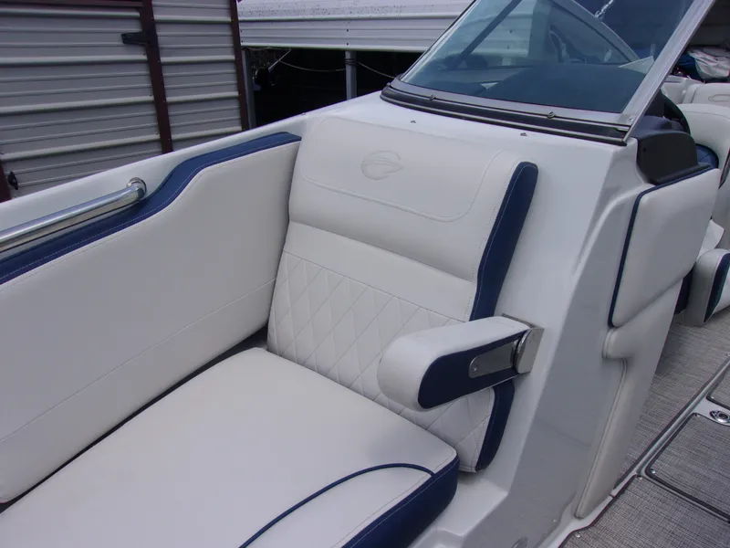 Slide: The Image of 2021 Crownline 210SS boat interior with white and blue seating. - 13