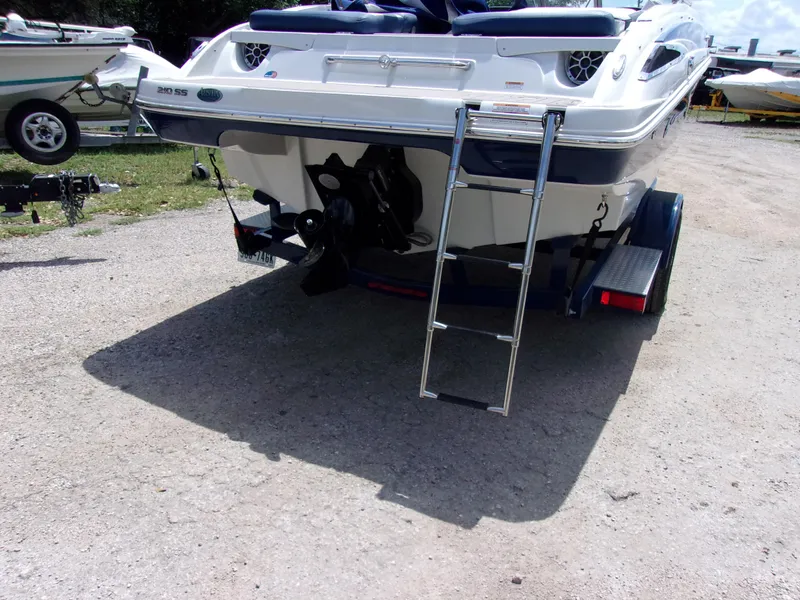 Slide: The Image of 2021 Crownline 210SS boat rear view with ladder on trailer. - 3