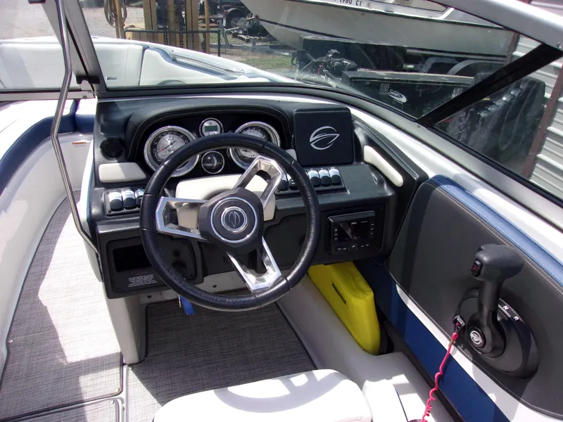 Slide: The Image of 2021 Crownline 210SS boat dashboard with steering wheel and control panel. - 4