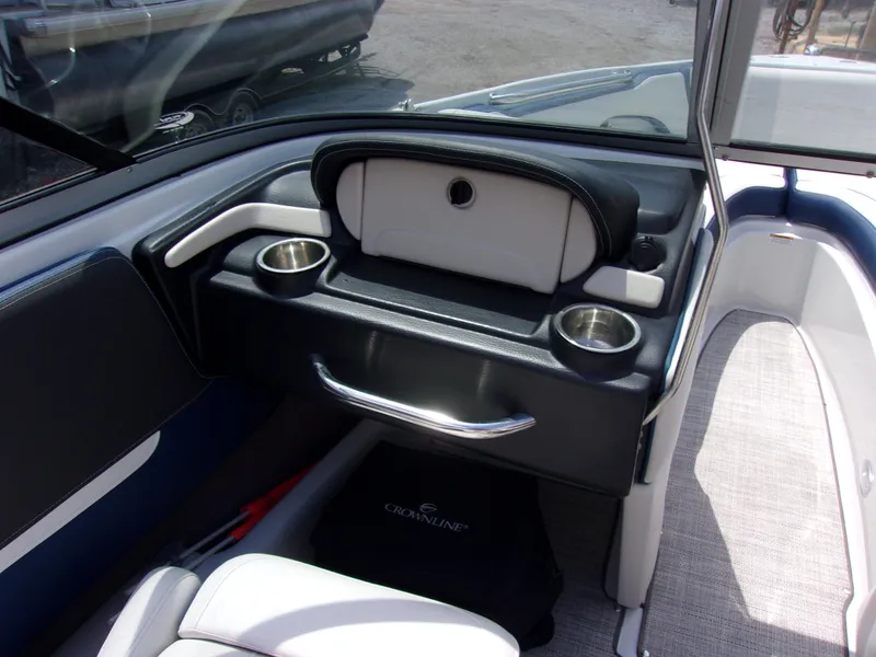 Slide: The Image of Interior of 2021 Crownline 210SS boat with cup holders and storage compartment. - 5