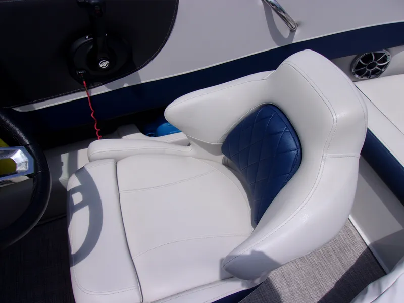 Slide: The Image of 2021 Crownline 210SS boat interior with white and blue cushioned seat. - 6
