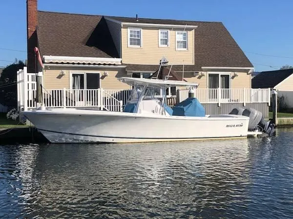 The Image of 2019 Regulator 31 FS boat docked by a waterfront house. - 0