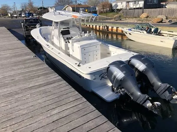 Slide: The Image of 2019 Regulator 31 FS boat docked with twin Yamaha engines. - 12