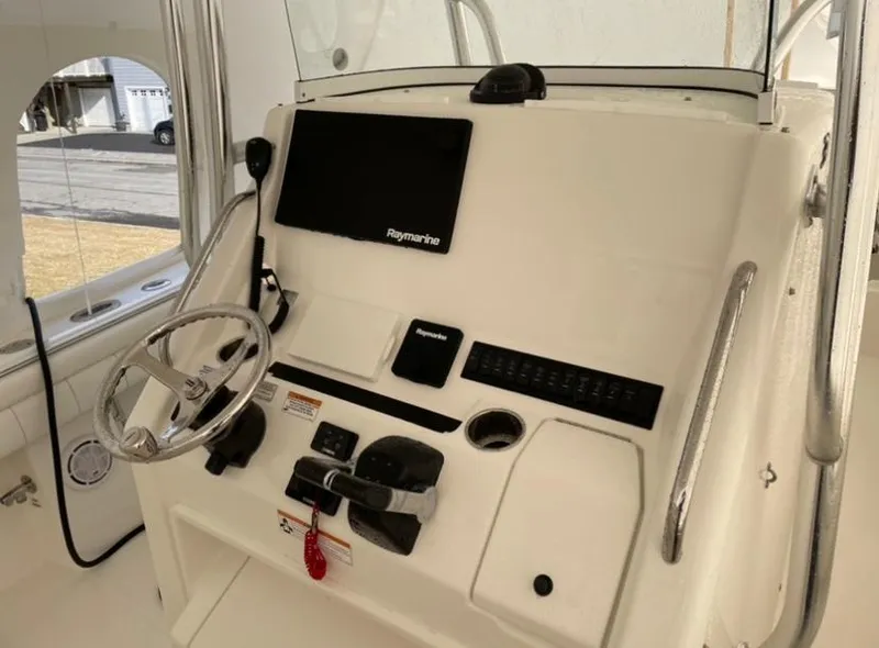 Slide: The Image of 2019 Regulator 31 FS boat console with steering wheel and Raymarine display. - 15