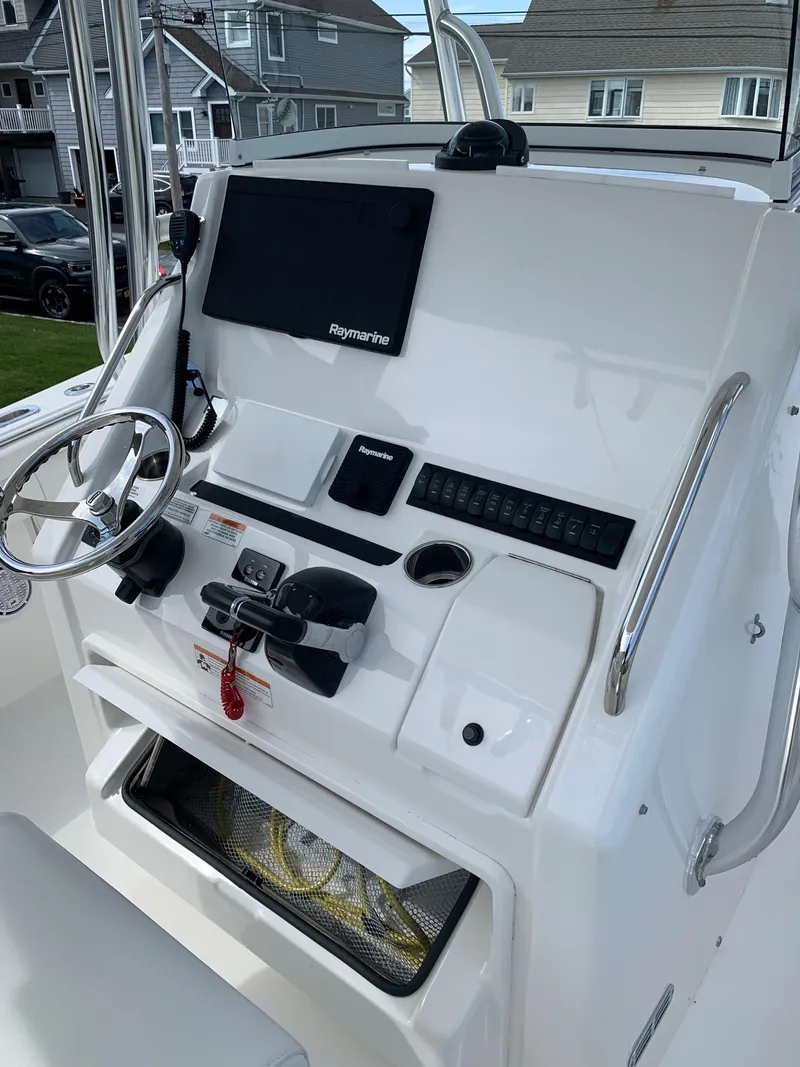 Slide: The Image of 2019 Regulator 31 FS boat console with steering wheel and navigation equipment. - 18