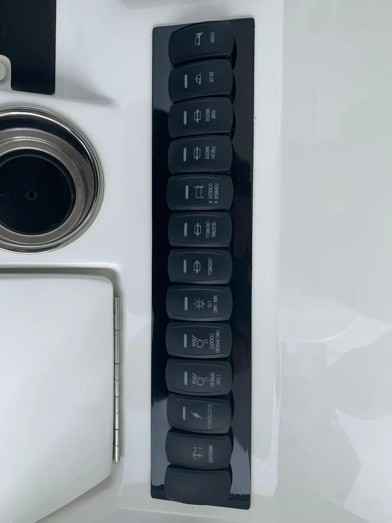 Slide: The Image of Control panel of a 2019 Regulator 31 FS boat with labeled switches. - 21