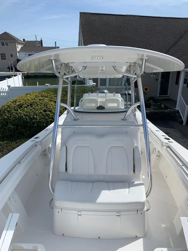 Slide: The Image of 2019 Regulator 31 FS boat with T-top and seating, docked near residential area. - 26
