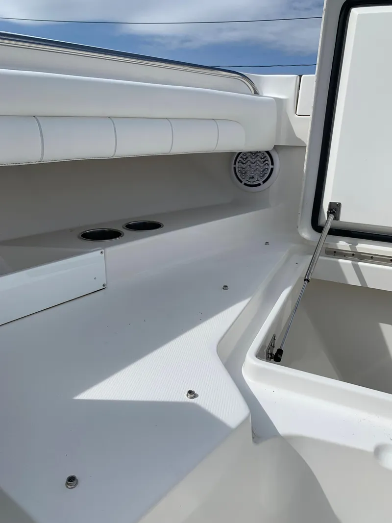 Slide: The Image of 2019 Regulator 31 FS boat interior with open storage compartment and cup holders. - 28