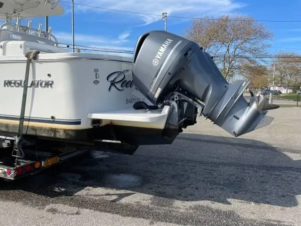 Slide: The Image of 2019 Regulator 31 FS boat with Yamaha outboard motor on trailer. - 32