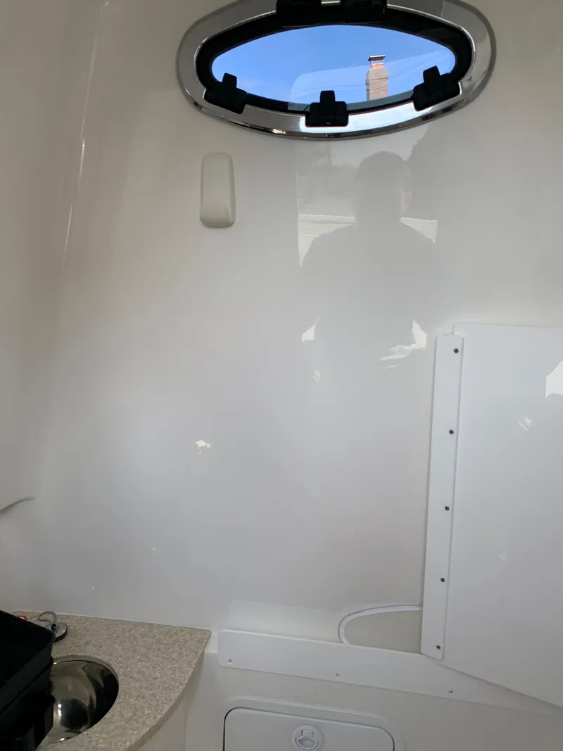 Slide: The Image of Interior of 2019 Regulator 31 FS boat with porthole and sink. - 38