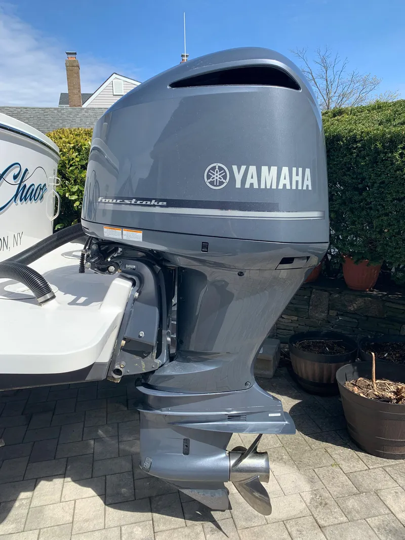 Slide: The Image of 2019 Regulator 31 FS with Yamaha outboard motor in a driveway setting. - 39