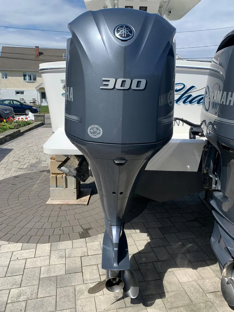 Slide: The Image of Yamaha 300 outboard motor on a 2019 Regulator 31 FS boat, parked on a paved driveway. - 40