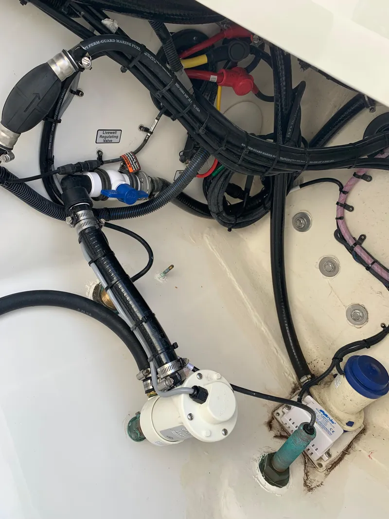 Slide: The Image of 2019 Regulator 31 FS boat wiring and plumbing components in the engine compartment. - 44