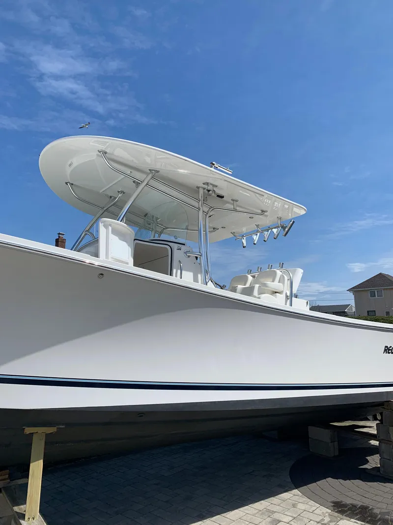 Slide: The Image of 2019 Regulator 31 FS boat with T-top under clear blue sky. - 8