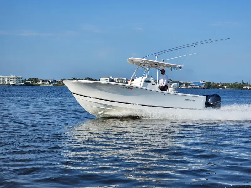 Slide: The Image of 2015 Regulator 25 boat cruising on a sunny day, with clear blue water and sky. - 22