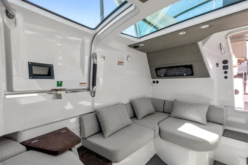 Slide: The Image of Luxurious interior of 2022 Axopar 37 Cross Cabin Brabus Trim with modern seating and skylight. - 22