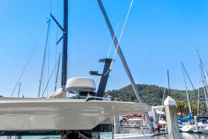 Slide: The Image of 2022 Axopar 37 Cross Cabin Brabus Trim docked in a marina, clear blue sky. - 27