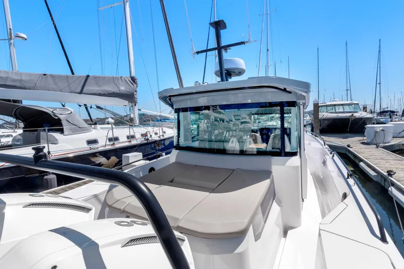 Slide: The Image of 2022 Axopar 37 Cross Cabin Brabus Trim docked at marina, showcasing sleek design. - 28