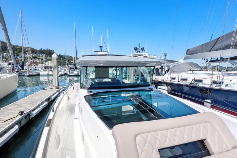 Slide: The Image of 2022 Axopar 37 Cross Cabin Brabus Trim docked in a marina, showcasing sleek design. - 31