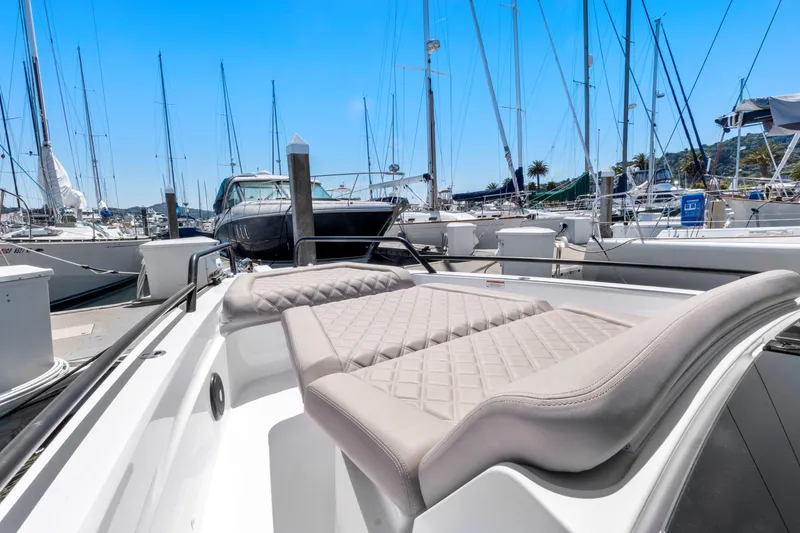 Slide: The Image of 2022 Axopar 37 Cross Cabin Brabus Trim at marina, featuring luxurious seating and sleek design. - 32