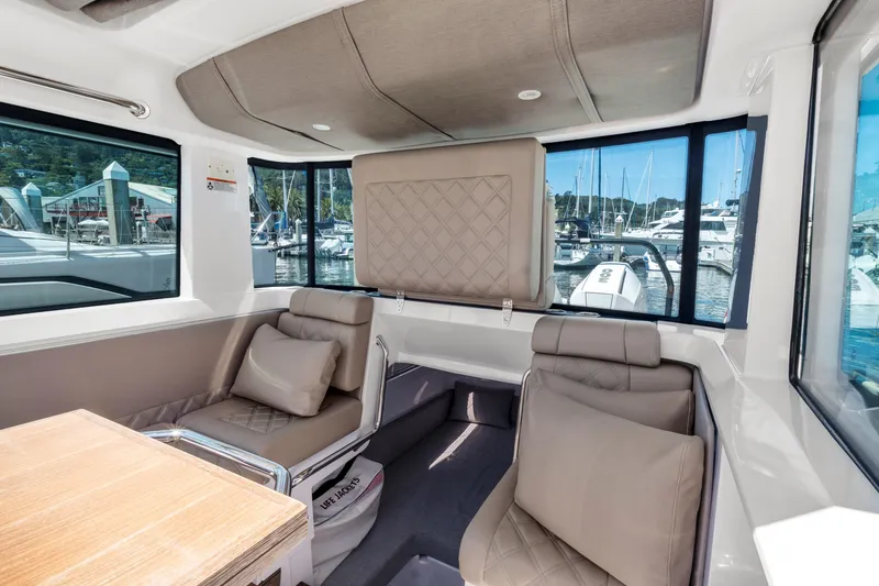 Slide: The Image of Interior of 2022 Axopar 37 Cross Cabin Brabus Trim, featuring luxurious seating and windows. - 35