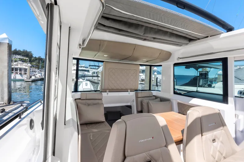 Slide: The Image of 2022 Axopar 37 Cross Cabin Brabus Trim interior with luxurious seating and panoramic windows. - 36