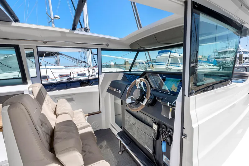 Slide: The Image of 2022 Axopar 37 Cross Cabin Brabus Trim interior with modern dashboard and seating. - 39