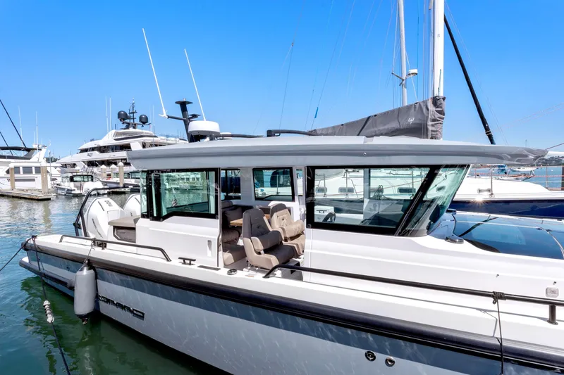 Slide: The Image of 2022 Axopar 37 Cross Cabin Brabus Trim docked in marina, showcasing sleek design. - 4