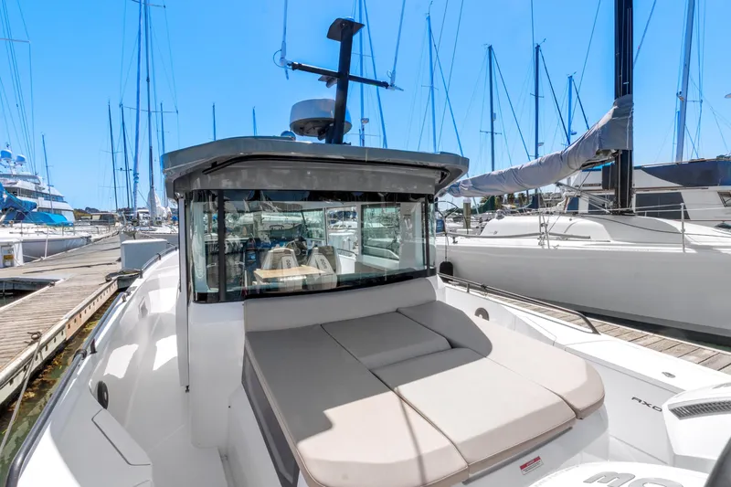 Slide: The Image of Axopar 37 Cross Cabin Brabus Trim 2022 docked at marina, surrounded by sailboats. - 41