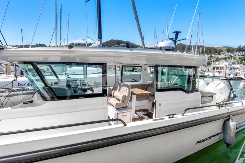 Slide: The Image of 2022 Axopar 37 Cross Cabin Brabus Trim docked in a marina. - 42