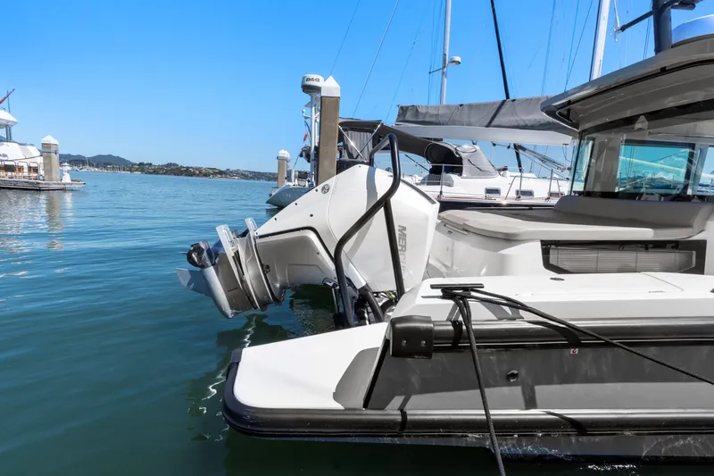 Slide: The Image of 2022 Axopar 37 Cross Cabin Brabus Trim docked at marina, showcasing sleek design and powerful engine. - 5