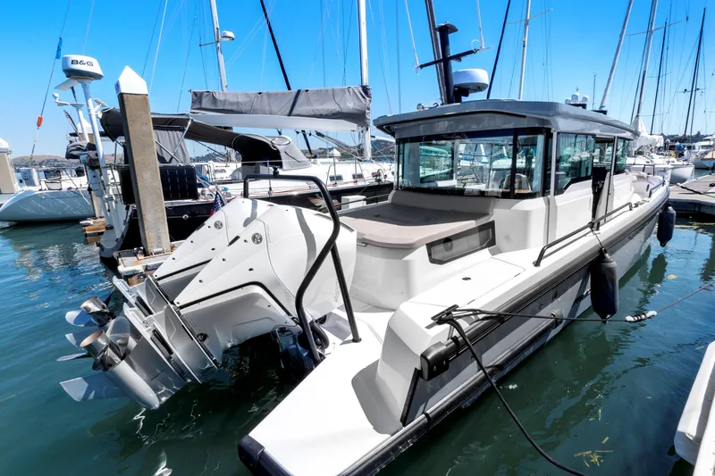 Slide: The Image of 2022 Axopar 37 Cross Cabin Brabus Trim docked in marina, showcasing sleek design and modern features. - 6